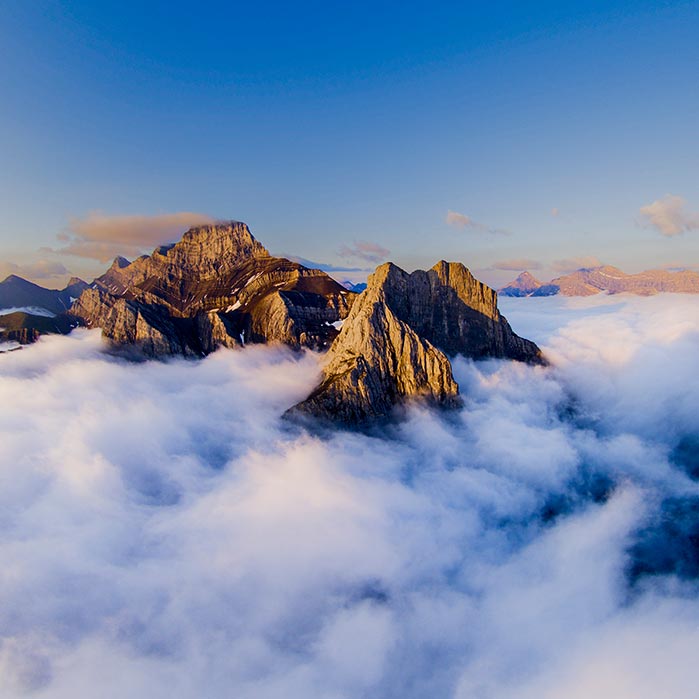 Mountains rising above cloud cover.